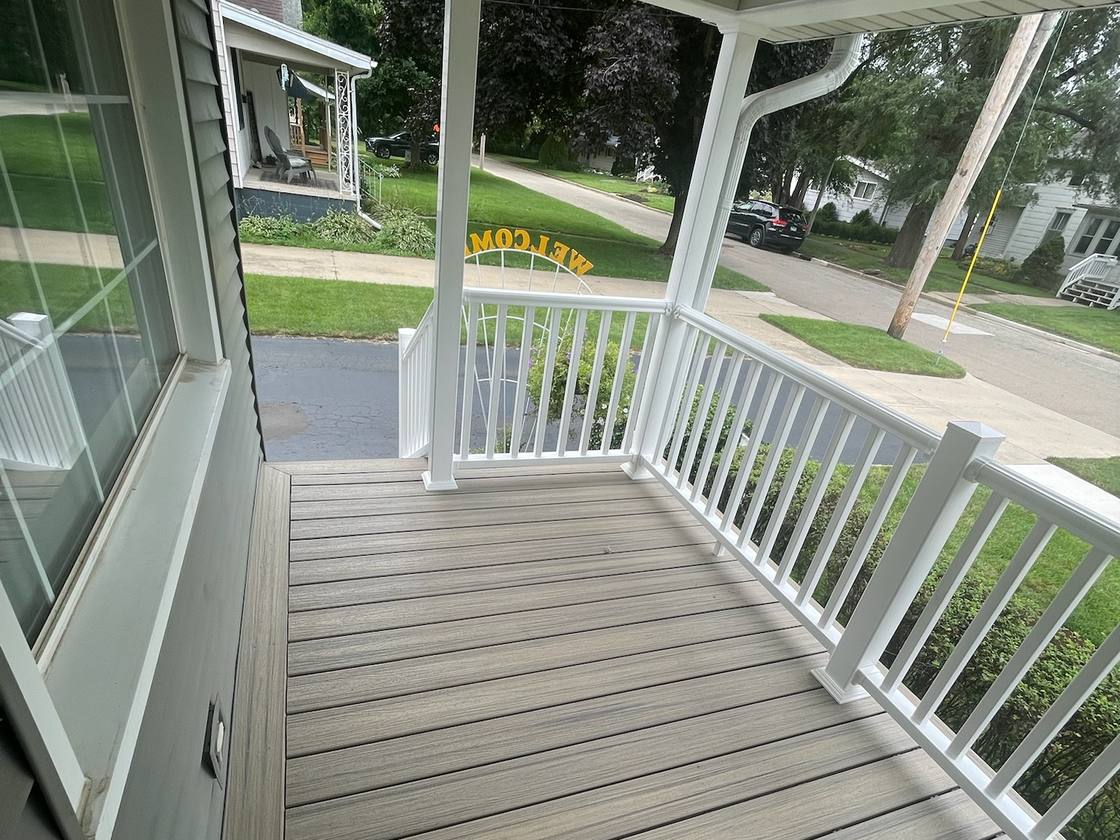Covered front entry with new composite decking and white railing