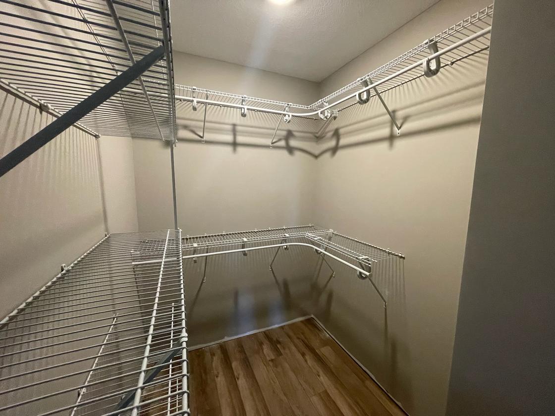 Walk-in closet with wrap-around shelves and hanging rods