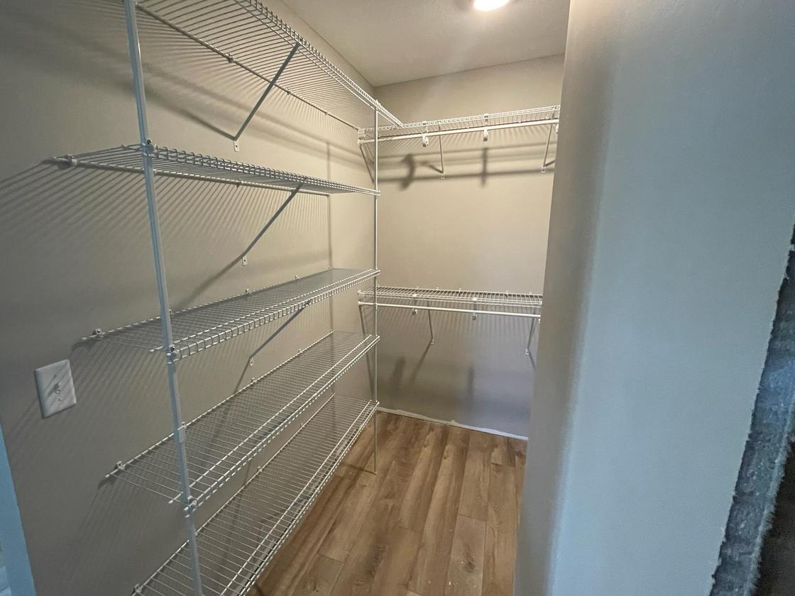 Walk-in closet with full-height wire shelving